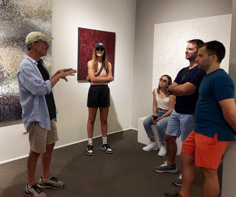 Artist Bill Pugh speaking with visitors during a Miami Circle Art Stroll