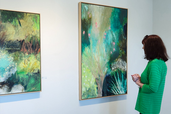 A viewer engaging with a painting
