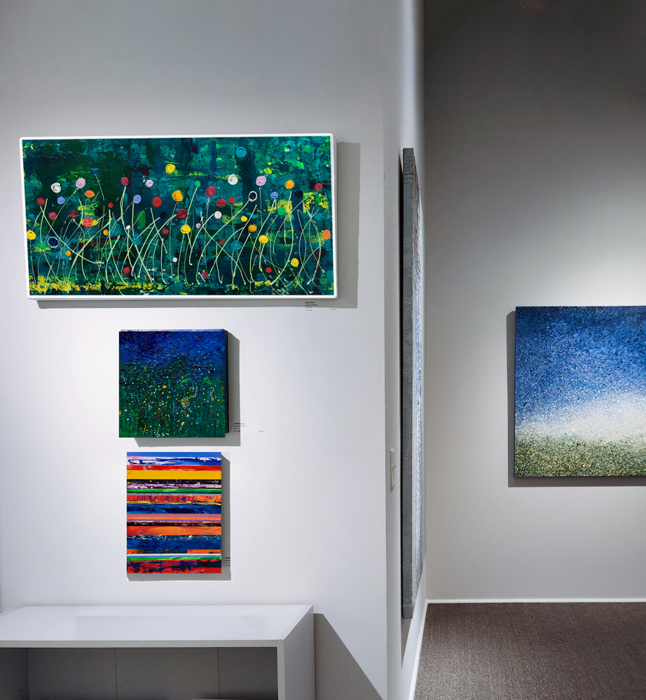 "Wildflowers #2a" hanging between two other paintings by w.e. pugh